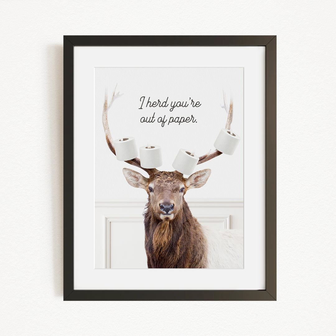 A deer with antlers wearing three rolls of toilet paper, accompanied by the text "I herd you're out of paper."