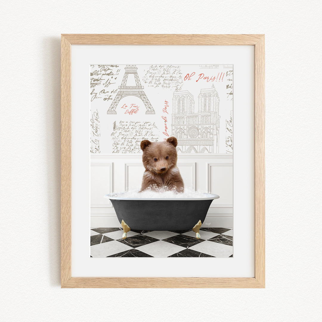A cute brown bear sitting in a bathtub filled with bubbles, surrounded by a checkered floor and a framed picture of the Eiffel Tower in the background.