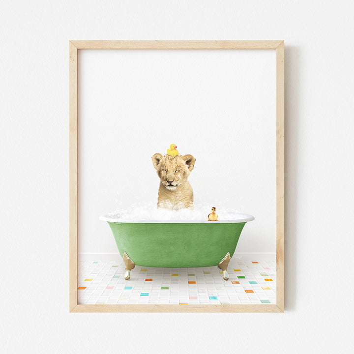 a framed photograph of a lion cub in a bathtub