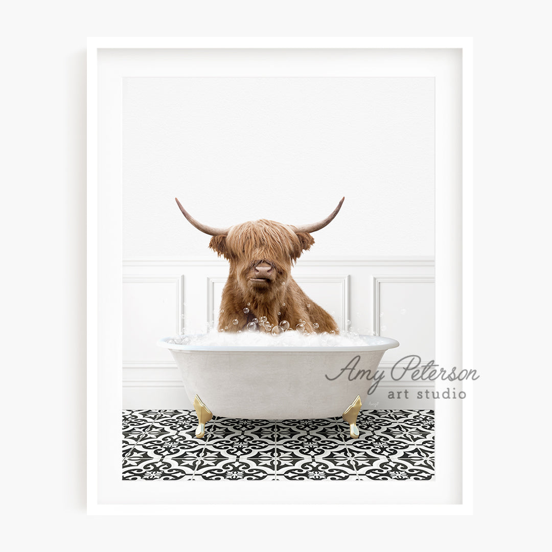 a brown dog sitting in a bathtub with long horns