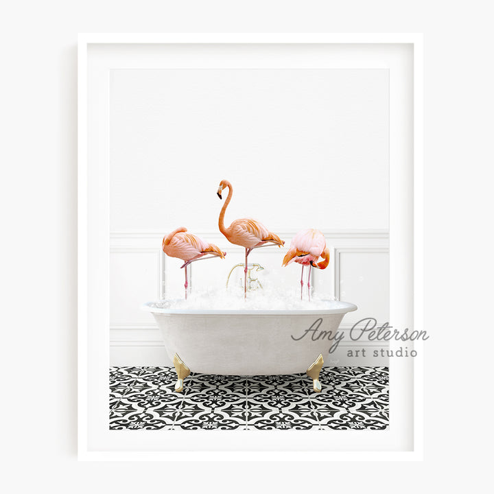 three pink flamingos in a bathtub with bubbles