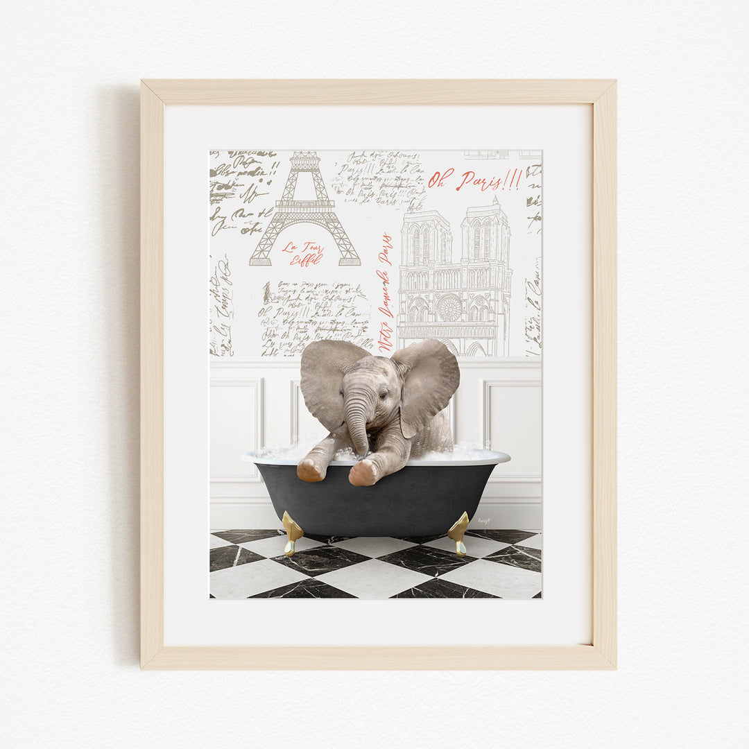 A framed image depicting a baby elephant sitting in a bathtub, with a Paris-themed background featuring the Eiffel Tower and other Parisian landmarks.