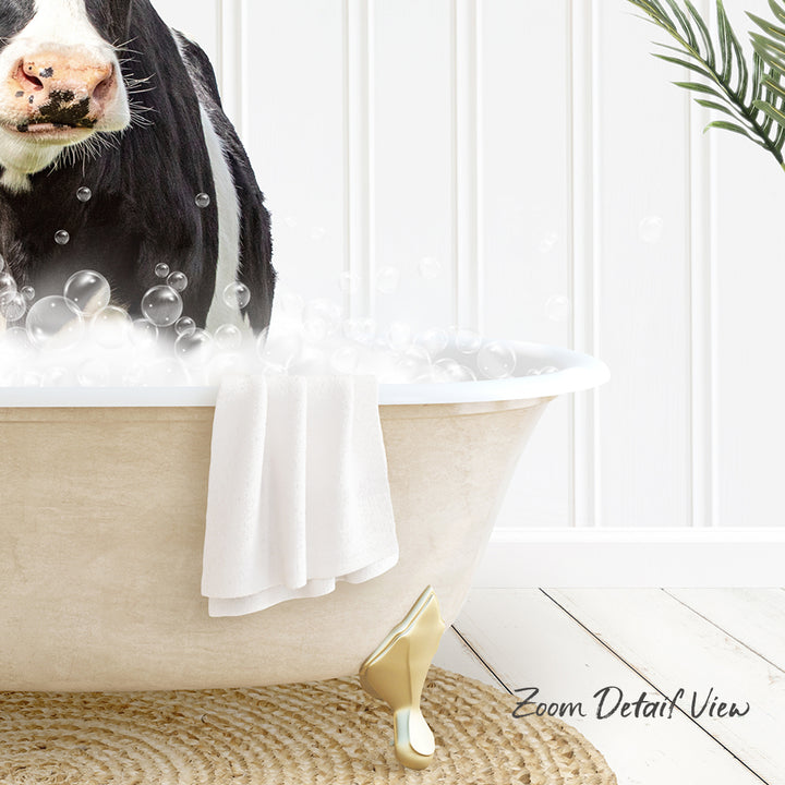 A cow is sitting in a bathtub filled with bubbles, with a towel draped over the side and a plant in the background.