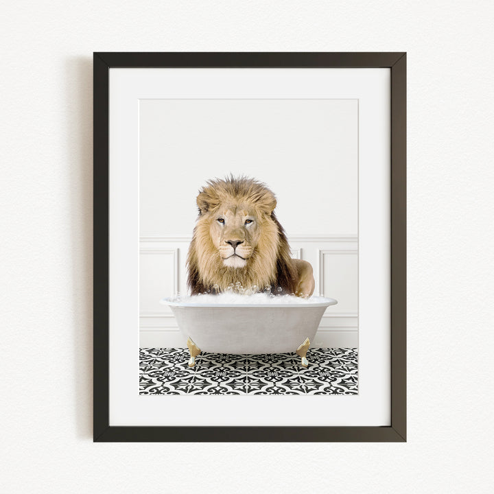 A lion is sitting in a white bathtub, surrounded by a black and white patterned rug.