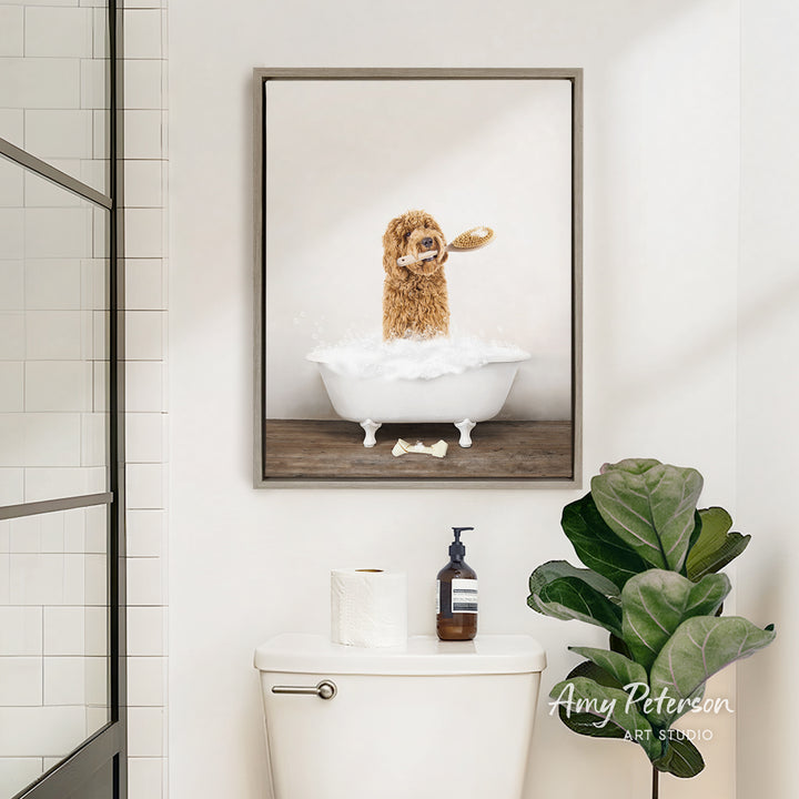 A framed image of a dog in a bathtub, with a toothbrush in its mouth, is displayed on the wall above a white toilet in a bathroom.