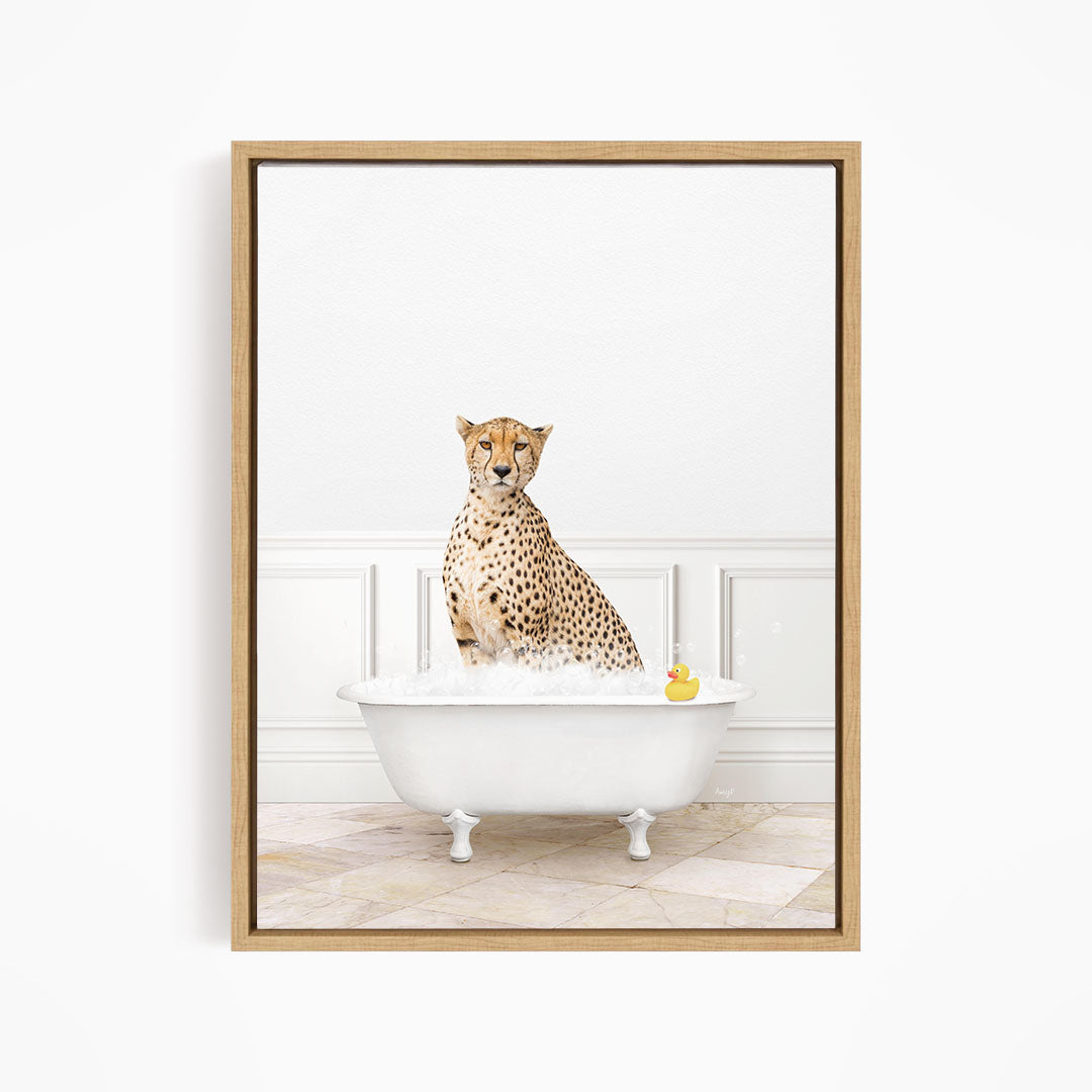 A cheetah sitting in a white bathtub filled with water, with a rubber duck floating in the water.