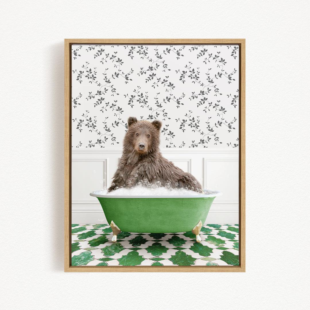 A brown bear sitting in a green bathtub filled with bubbles, surrounded by a patterned green and white rug.