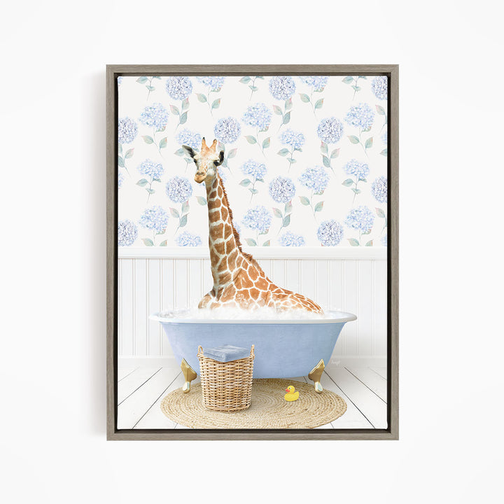 A giraffe is sitting in a blue bathtub filled with water, surrounded by a wicker basket and rubber ducks.