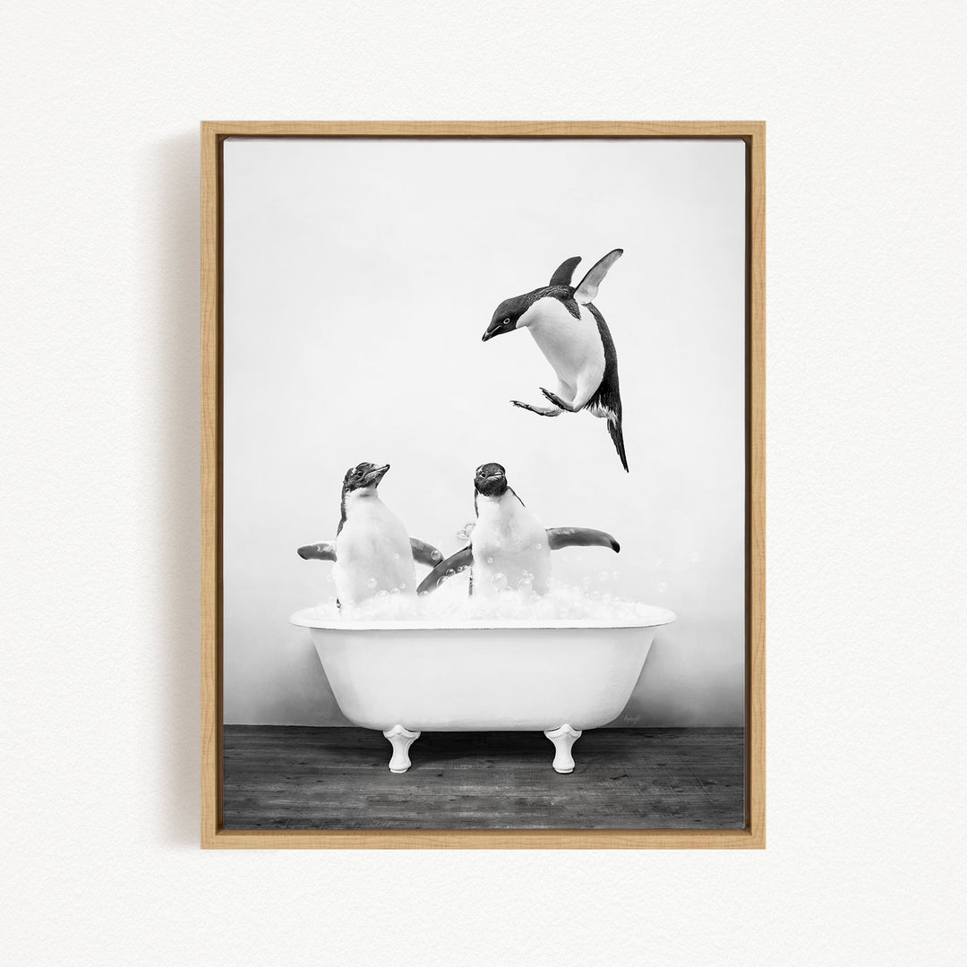 A black and white photograph of two penguins sitting in a bathtub, with one penguin jumping out of the tub.