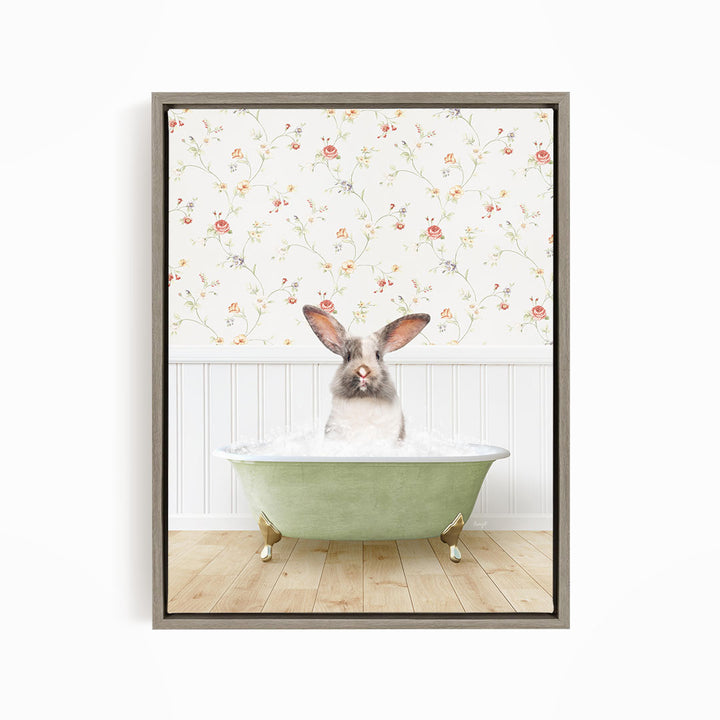 A rabbit sitting in a green bathtub filled with water, with a floral wallpaper in the background.