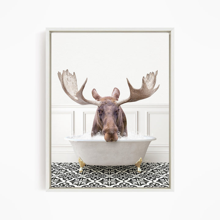 A moose with large antlers is sitting in a bathtub filled with water, creating a whimsical and humorous scene.