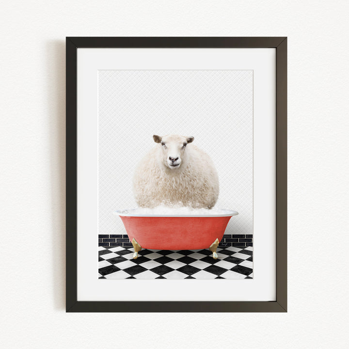 A fluffy white sheep sits in a red bathtub on a black and white checkered floor, looking directly at the camera.