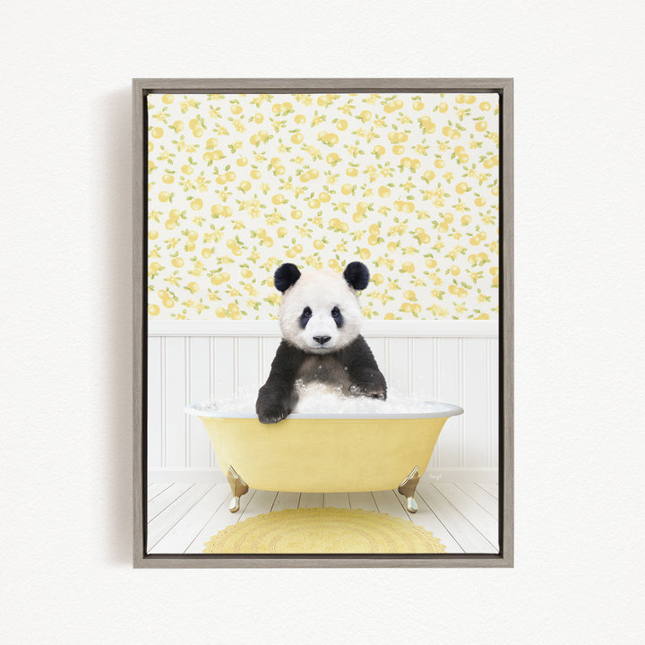 A panda bear sitting in a yellow bathtub, surrounded by a yellow and white floral pattern on the wall behind it.