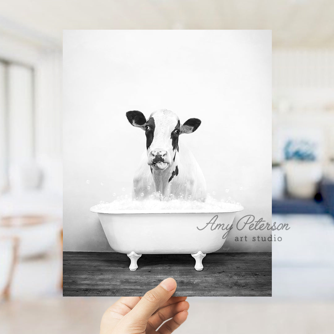 a black and white photo of a cow in a bathtub