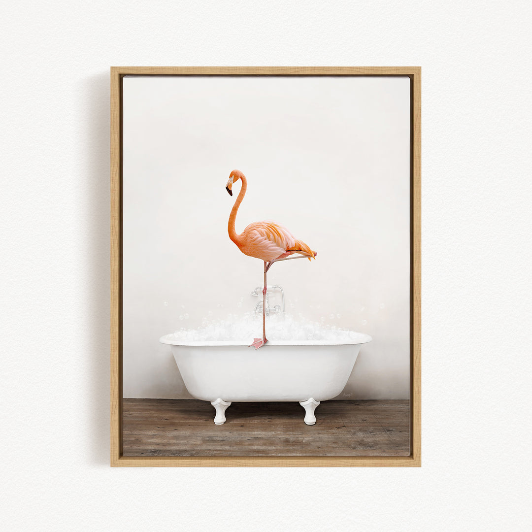 A vibrant flamingo stands on the edge of a white bathtub, creating a whimsical and playful scene.