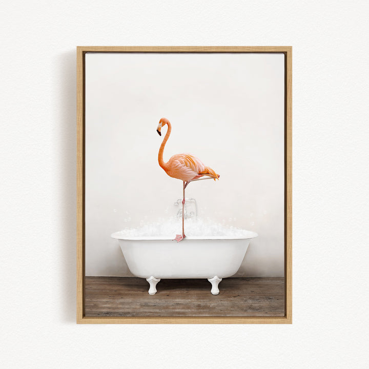 A vibrant flamingo stands on the edge of a white bathtub, creating a whimsical and playful scene.