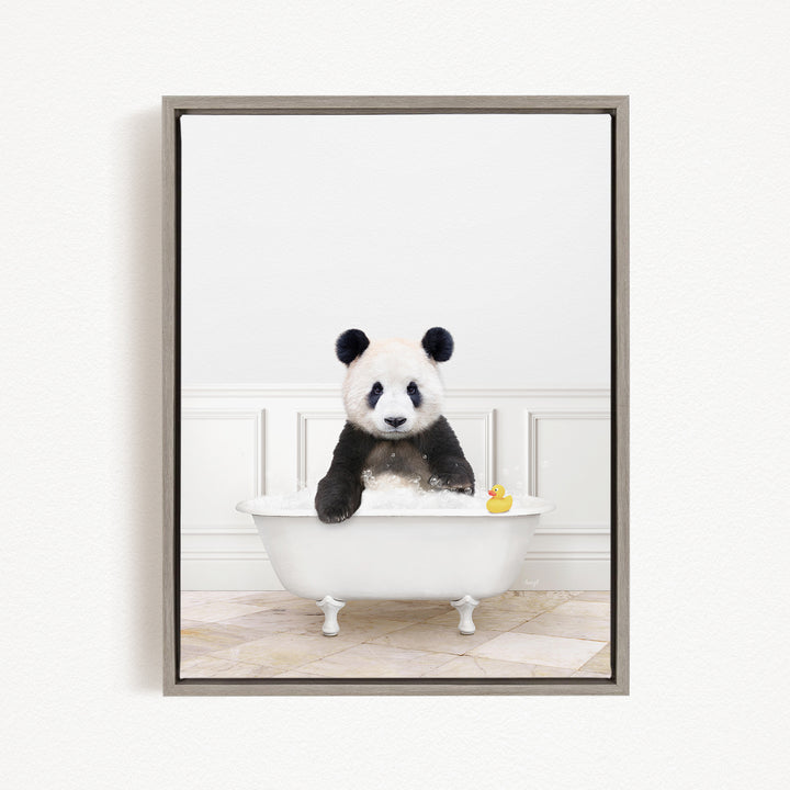 A panda bear sitting in a white bathtub, surrounded by a yellow rubber duck.