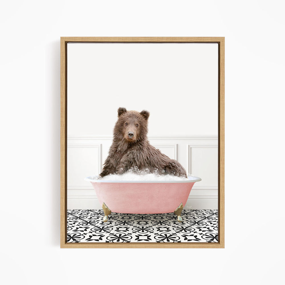 A brown bear sitting in a pink bathtub filled with bubbles, surrounded by a black and white patterned floor.