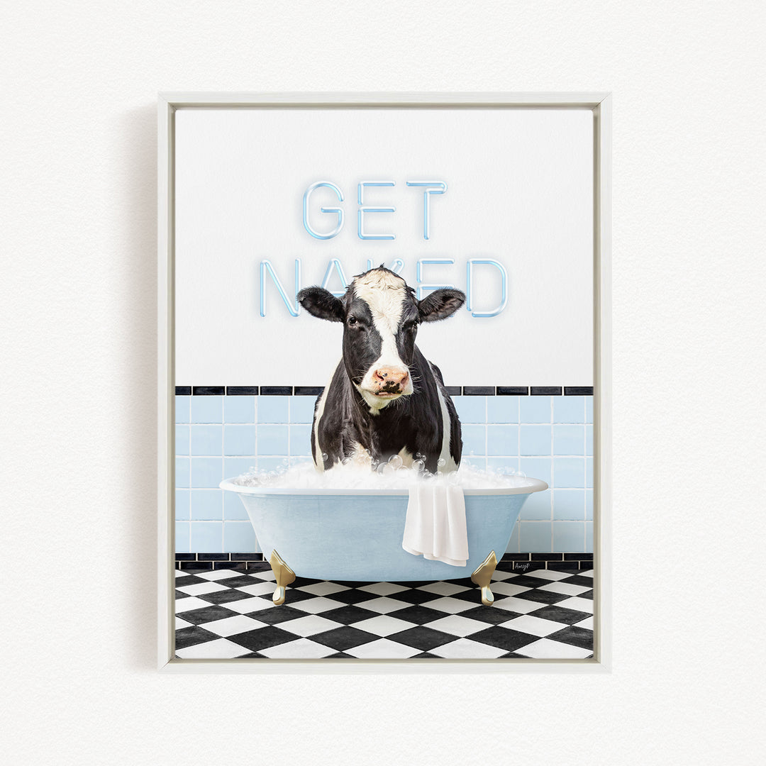 A black and white cow is sitting in a bathtub filled with water, with the words "GET NANED" written on the wall behind it.