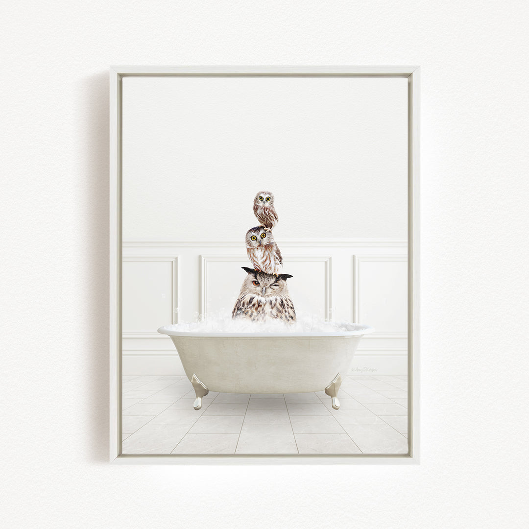 A white bathtub filled with water, with three owls perched on top of it.
