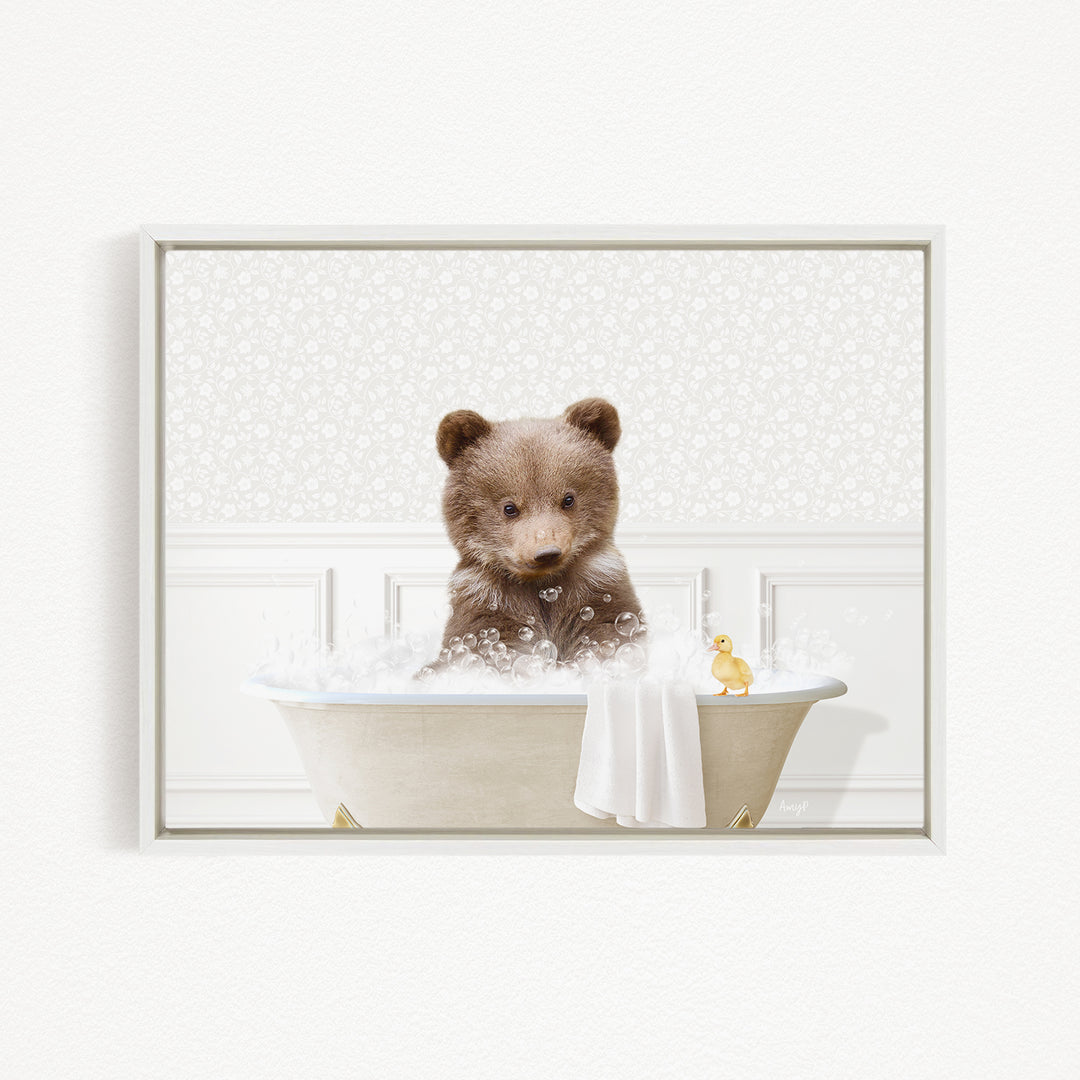 A brown bear sitting in a bathtub filled with bubbles, with a yellow duck nearby.