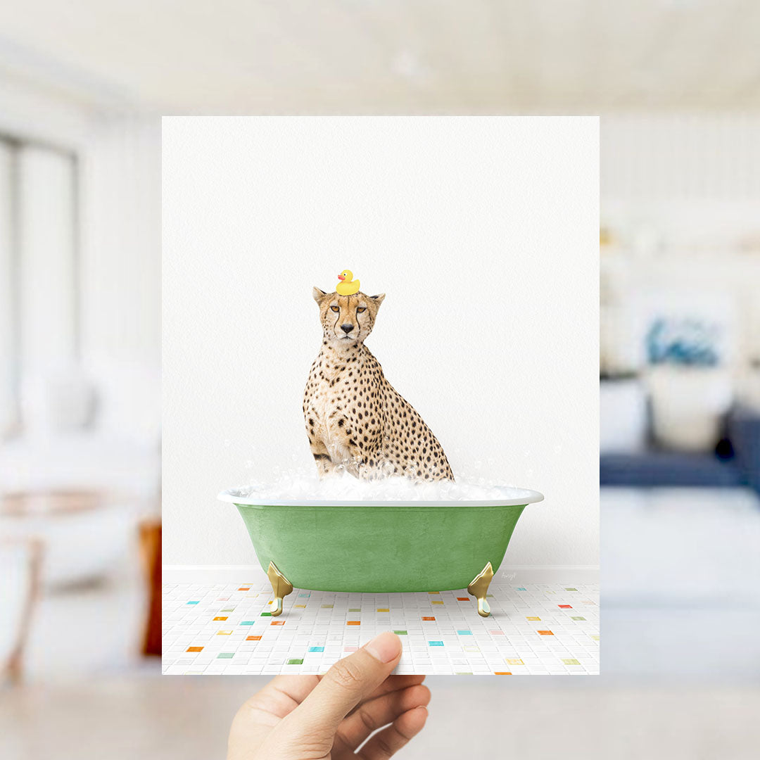 A cheetah sitting in a green bathtub filled with bubbles, wearing a yellow rubber duck hat.