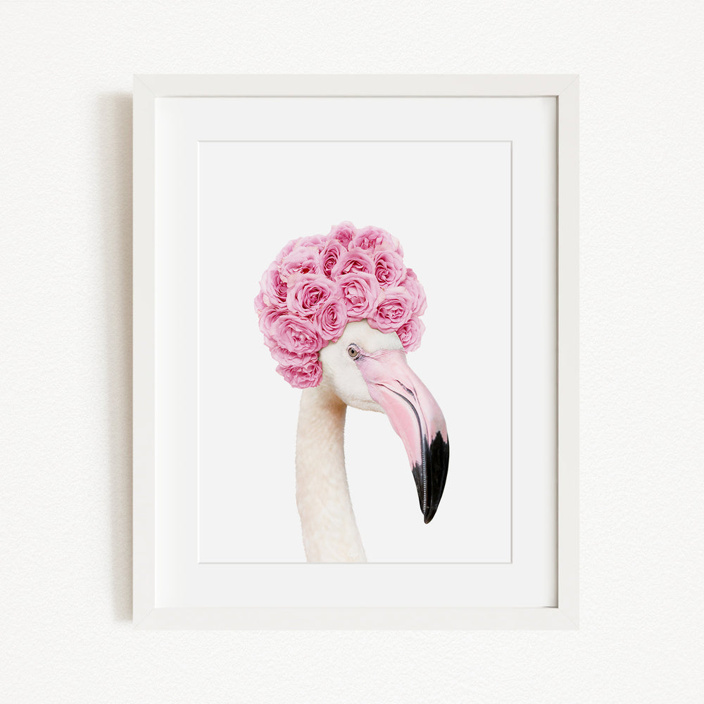 A framed image of a flamingo with a pink flower crown on its head.