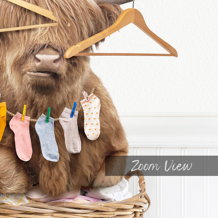 A furry animal, possibly a yak or a cow, is hanging socks on a clothesline with clothespins.