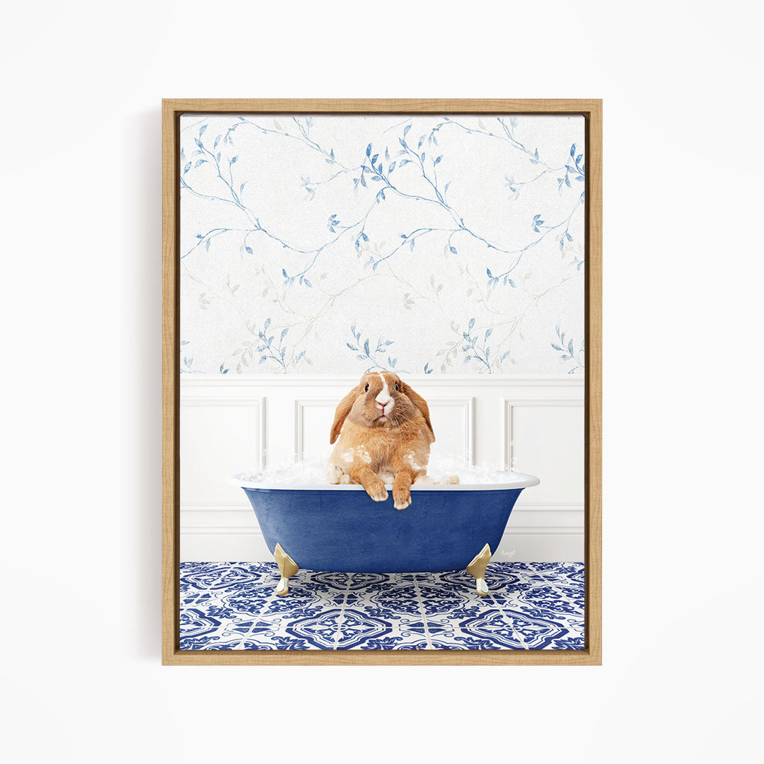 A brown rabbit sitting in a blue bathtub filled with water, surrounded by a blue and white patterned rug on the floor.