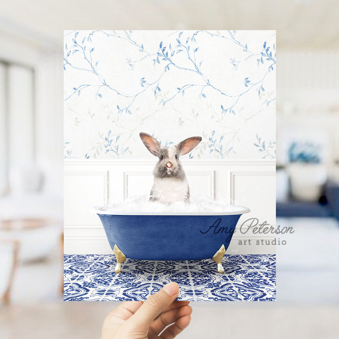 a person holding a card with a picture of a rabbit in a bathtub