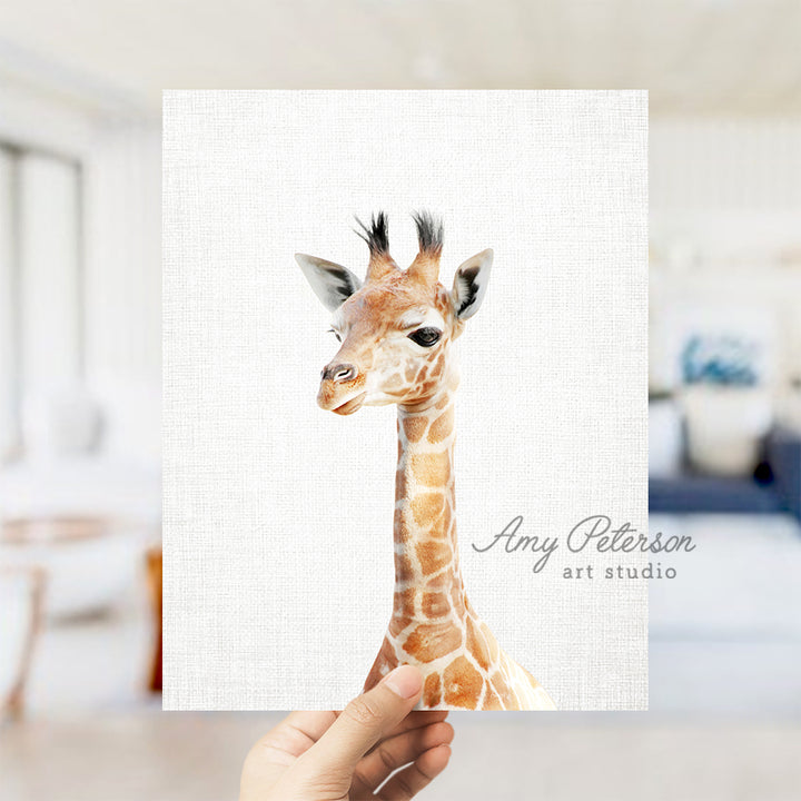 a hand holding a card with a picture of a giraffe