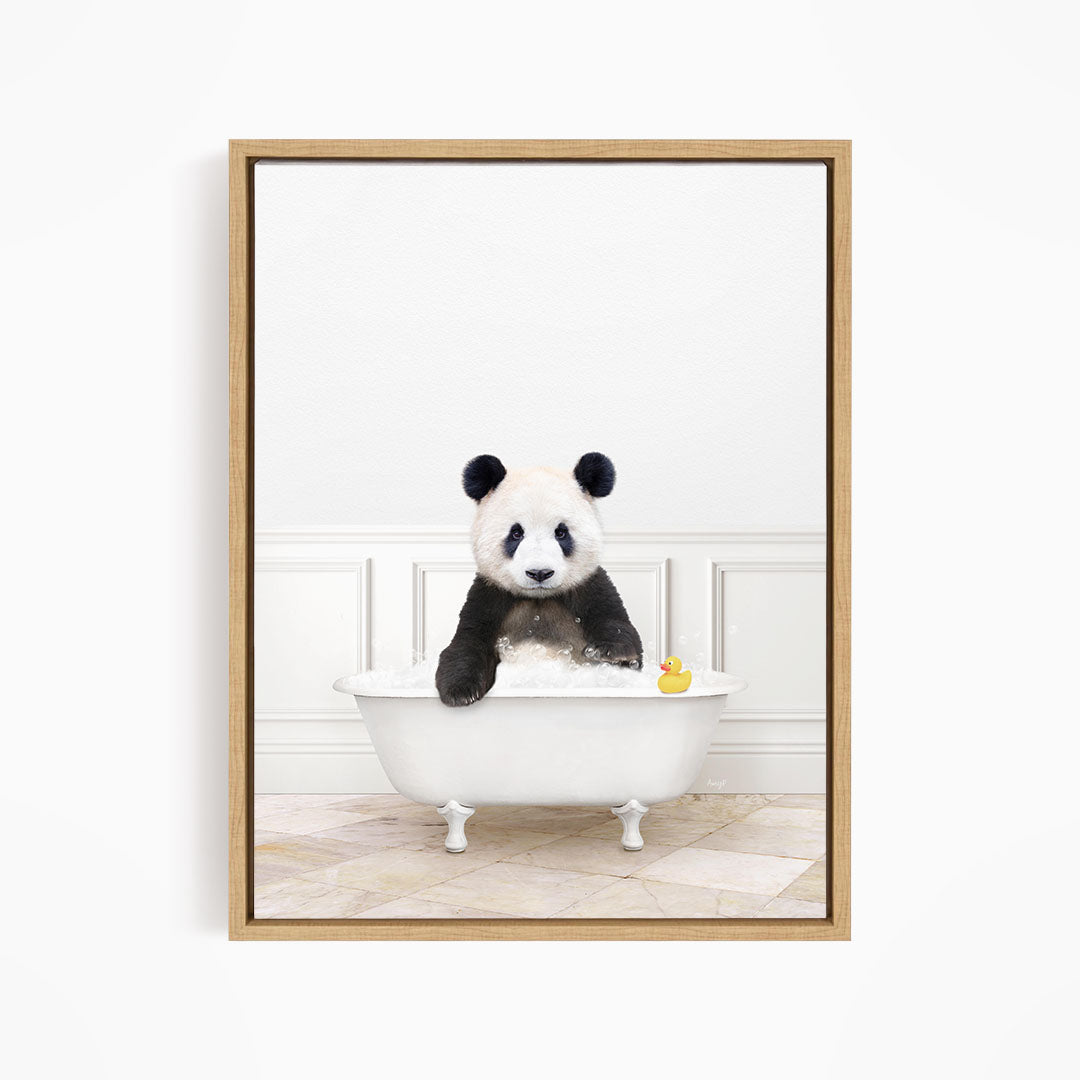 A panda bear sitting in a white bathtub, with a rubber duck floating in the water.