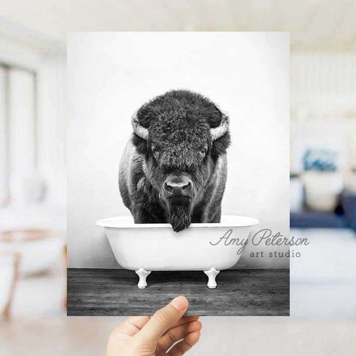 a black and white photo of a bison in a bathtub