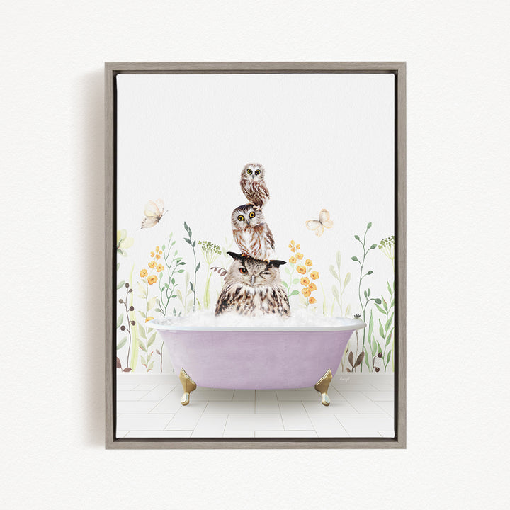 A framed illustration depicting three owls sitting in a bathtub filled with water, surrounded by flowers and butterflies.