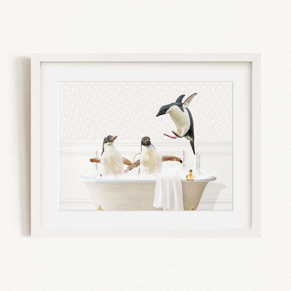 A framed image depicting three penguins enjoying a bath in a white bathtub, with one penguin standing on the edge of the tub and another sitting inside.