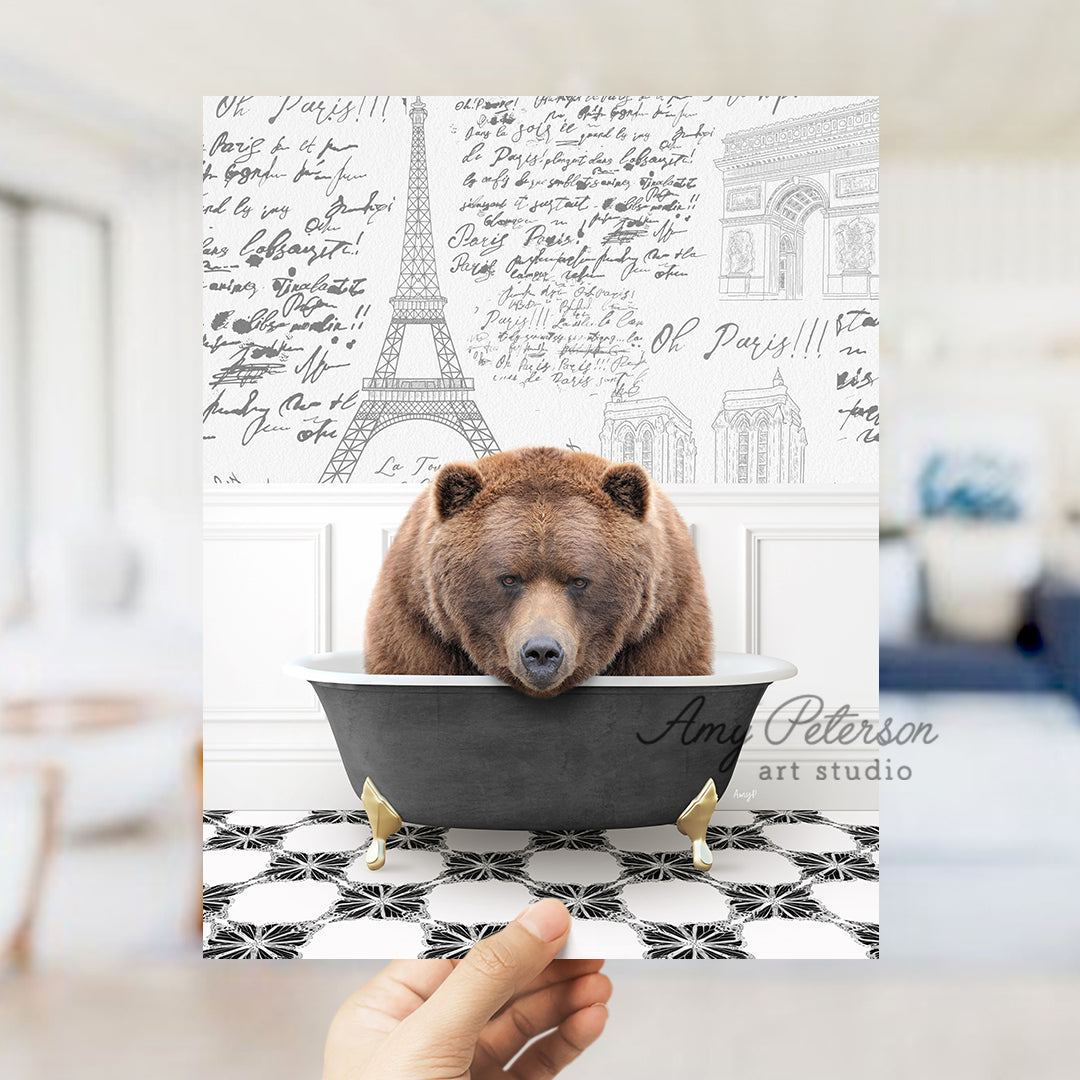 a person holding up a card with a bear in a bathtub