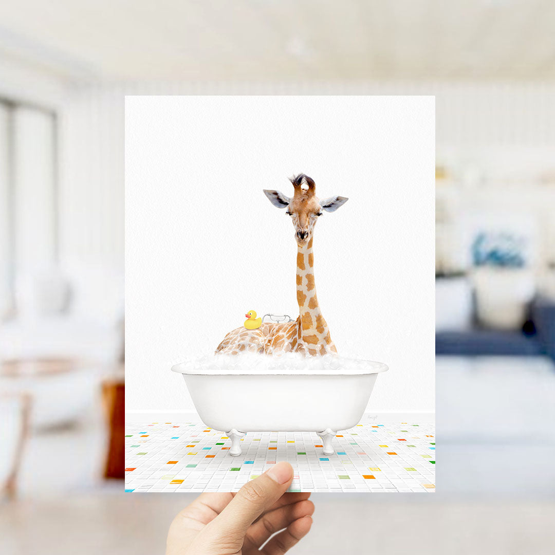 A giraffe sitting in a bathtub filled with bubbles, with a yellow rubber duck nearby.