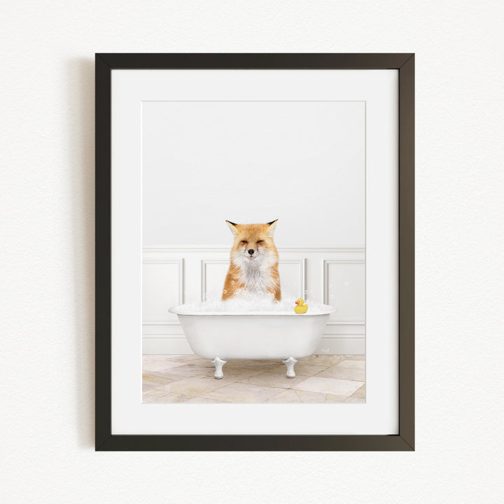 A red fox is sitting in a white bathtub filled with water, with a yellow rubber duck floating in the water.