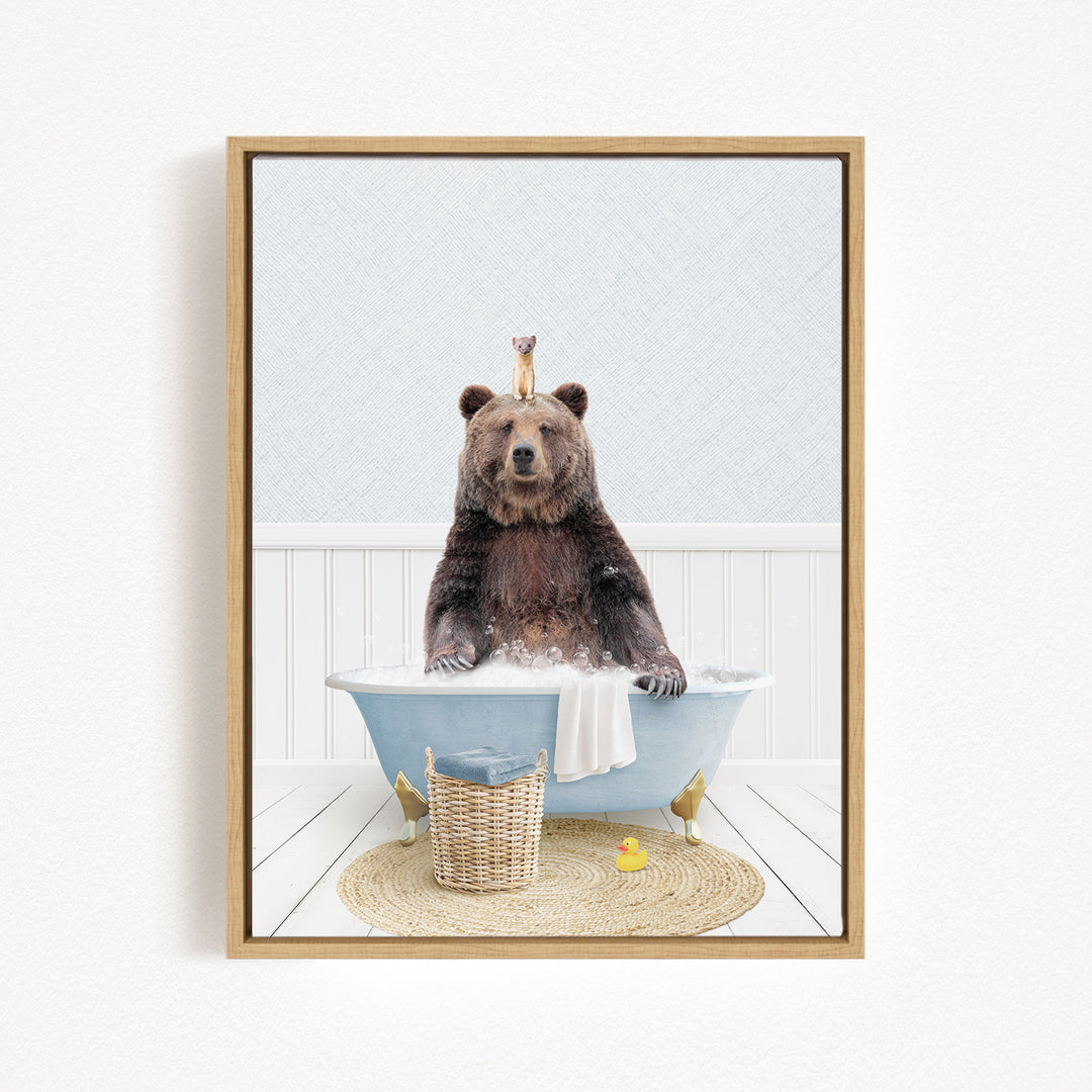 A brown bear sitting in a blue bathtub, surrounded by a basket of toys and a yellow rubber duck.