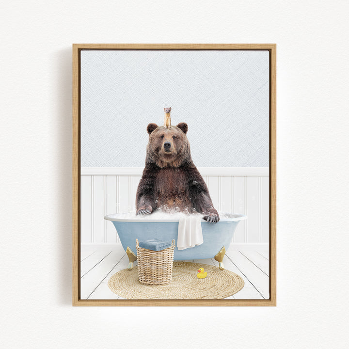 A brown bear sitting in a blue bathtub, surrounded by a basket of toys and a yellow rubber duck.