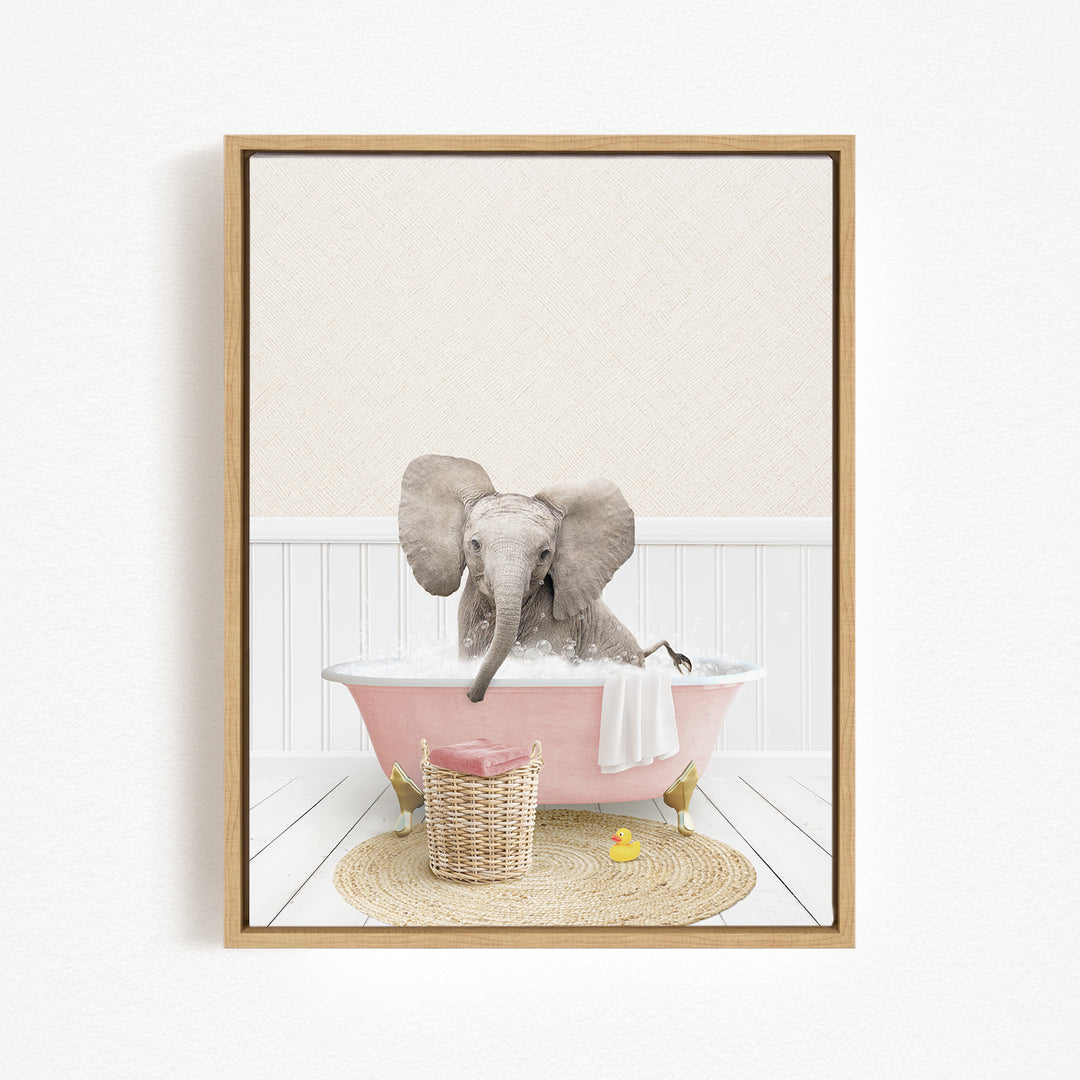 A gray elephant is sitting in a pink bathtub filled with water, surrounded by a basket of toys and a yellow rubber ducky.