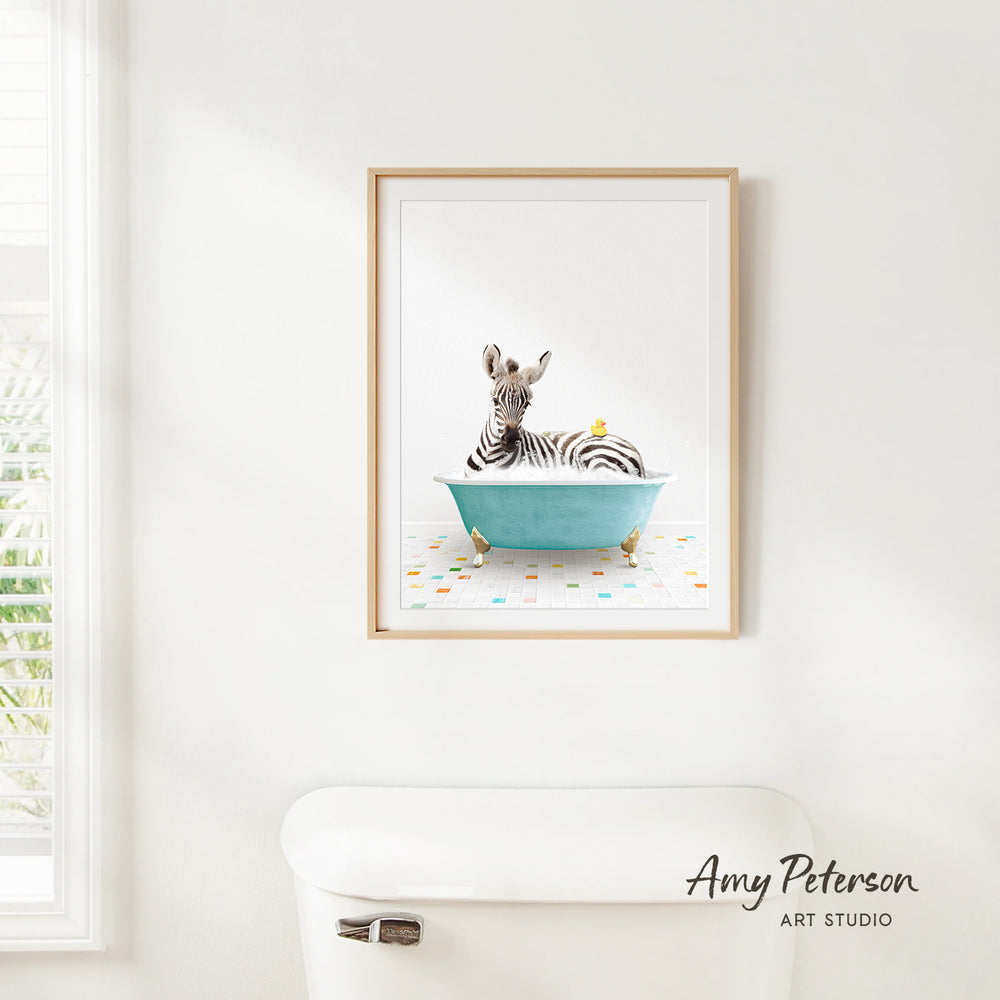 A framed print of a zebra sitting in a blue bathtub, with a yellow bird perched on the zebra's back.