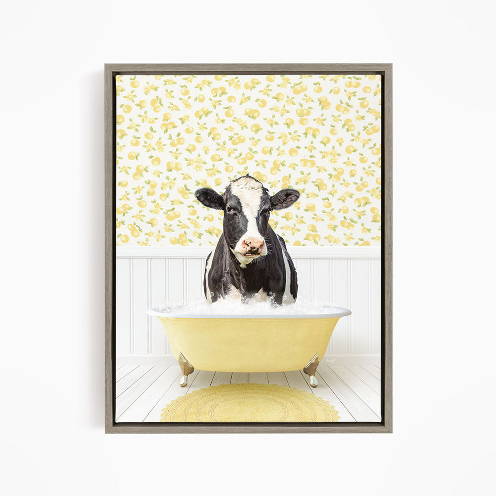 A black and white cow is standing in a yellow bathtub filled with water, surrounded by a yellow floral pattern on the wall behind it.