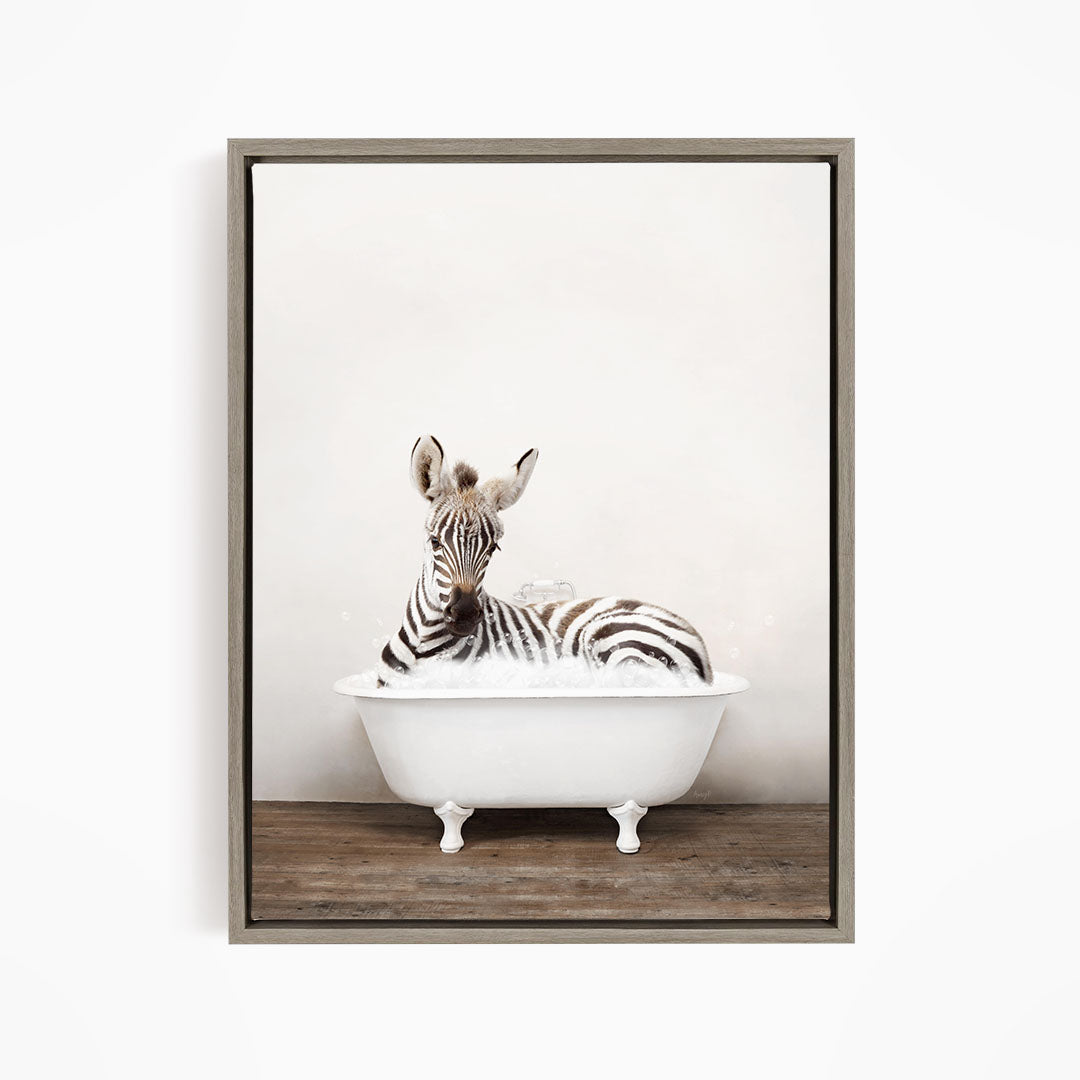 A zebra is sitting in a white bathtub, appearing relaxed and enjoying the bath.