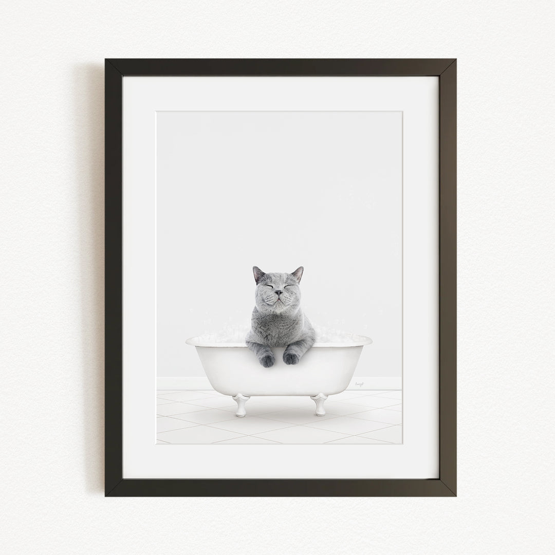 A gray cat sitting in a white bathtub, looking content and relaxed.