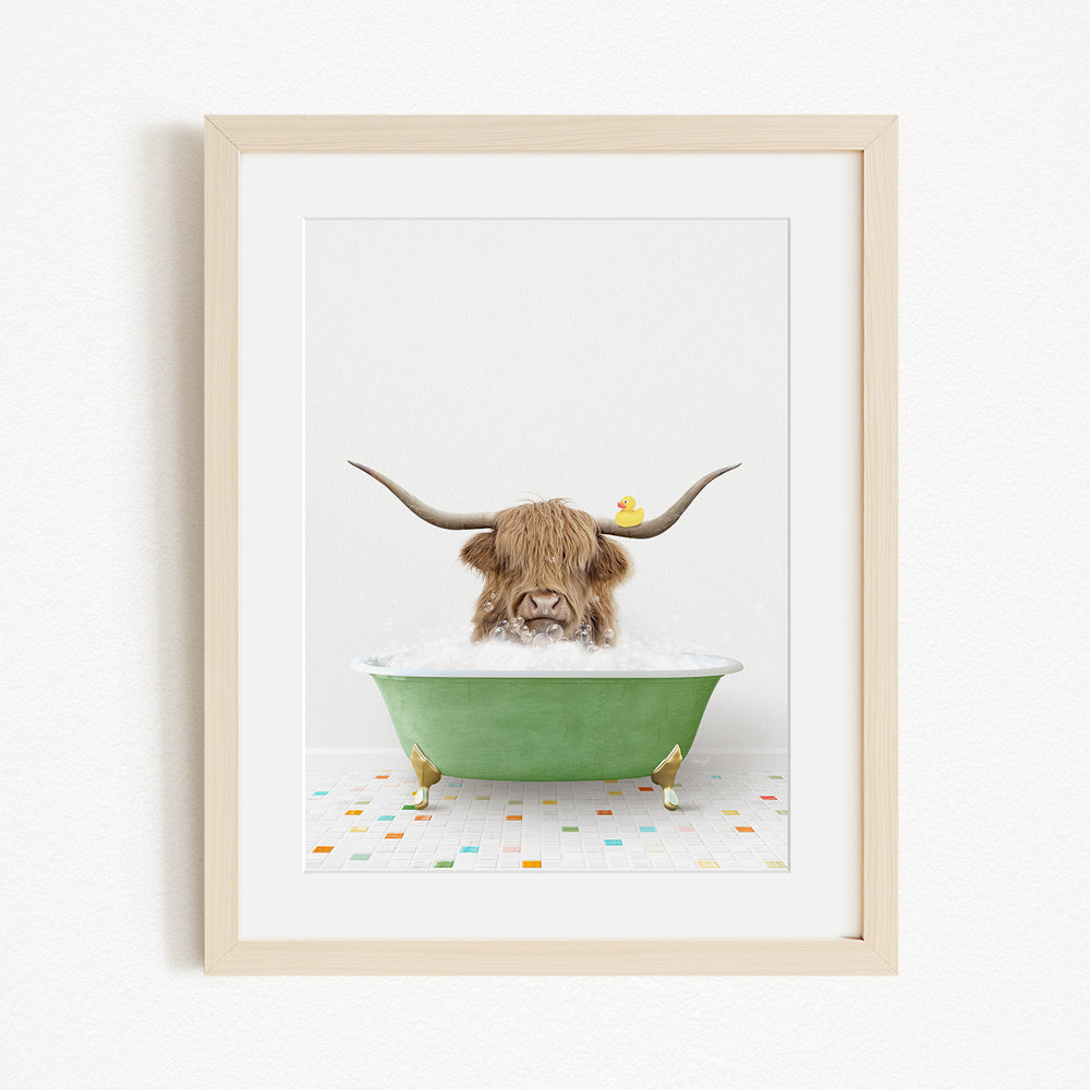 A brown cow with long horns is sitting in a green bathtub, surrounded by colorful tiles on the floor.