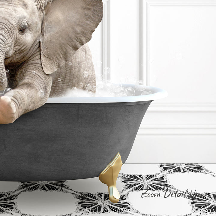 A baby elephant sitting in a bathtub filled with water, surrounded by bubbles.