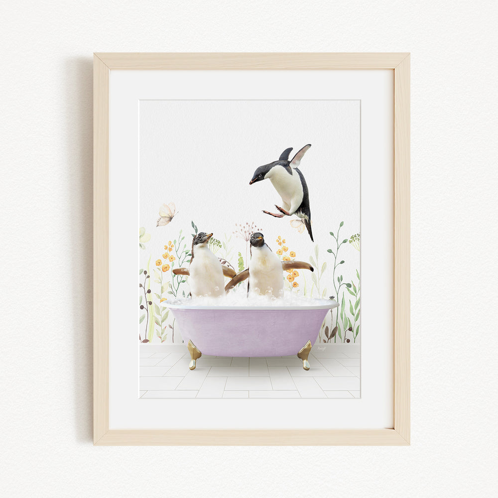 A framed image depicting two penguins sitting in a bathtub filled with bubbles, surrounded by flowers and butterflies.