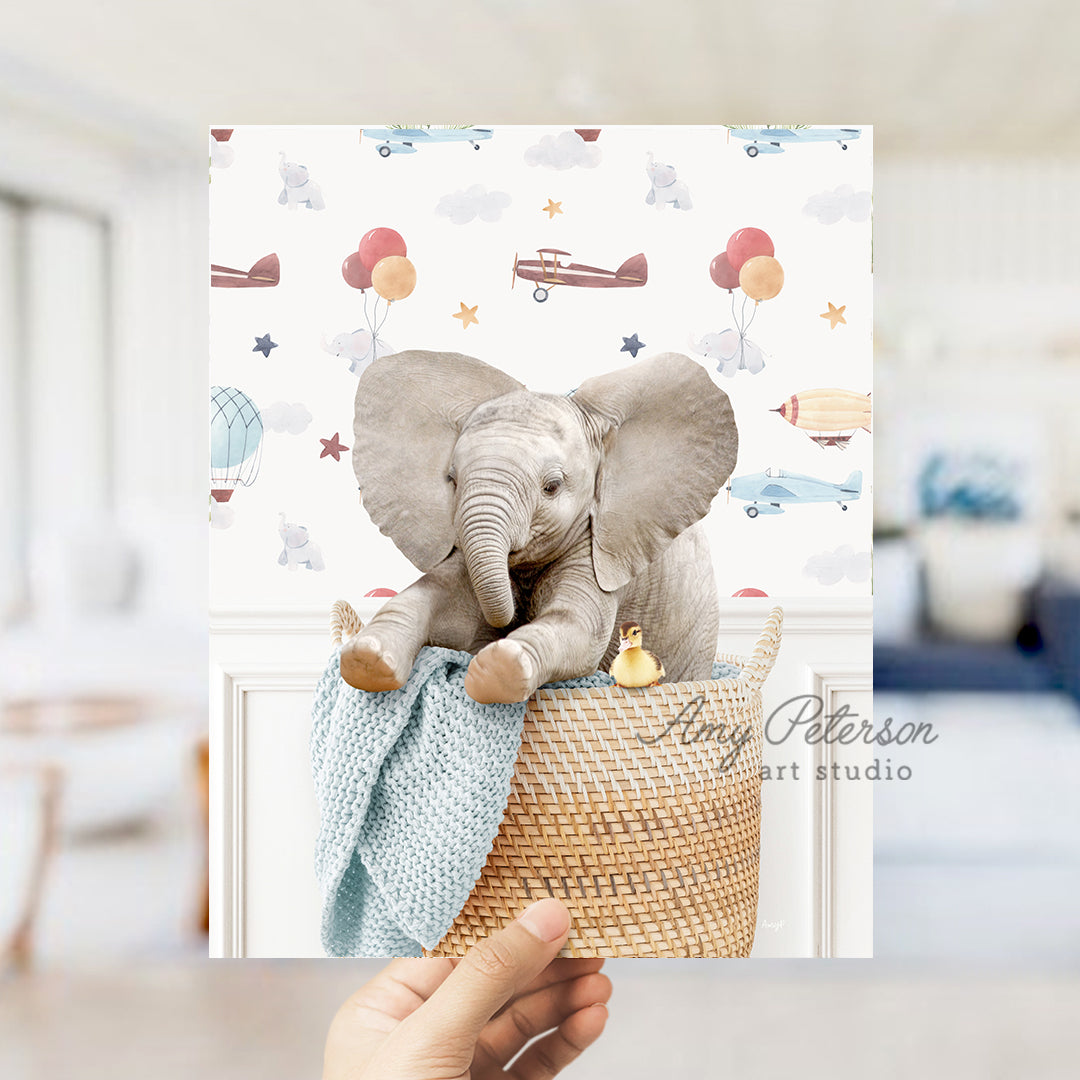 a person holding up a card with an elephant on it