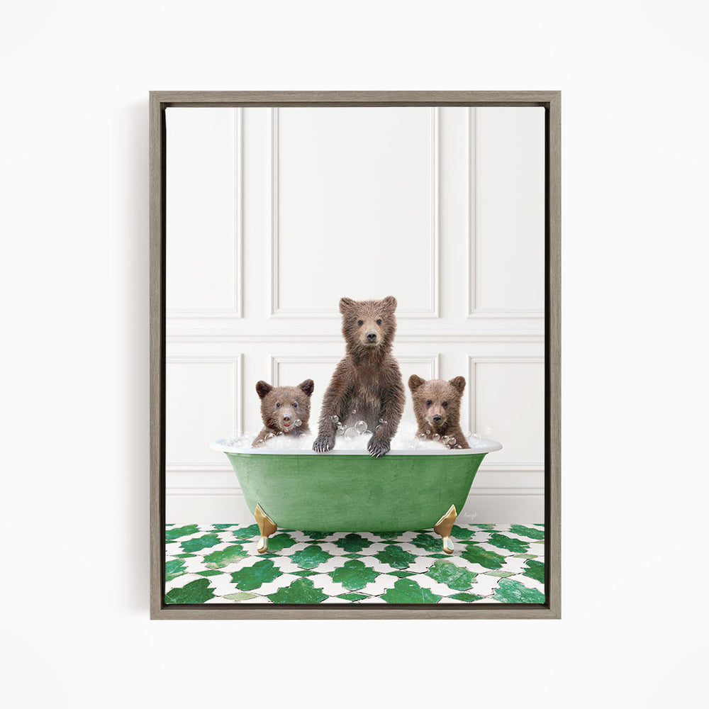 A framed image depicting three bears sitting in a green bathtub filled with water, with a patterned green and white floor beneath them.